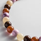 Close-up of glossy pink, brown and cream beads on the BaubleBar Mini Jane Beaded Necklace