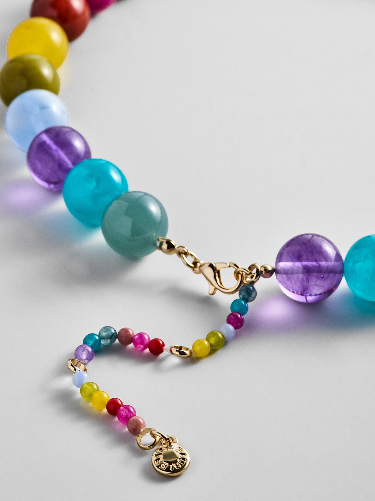 Gold-tone lobster clasp and colorful beaded extender on the BaubleBar Mini Jane Beaded Necklace in Multi.