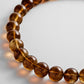 Close-up of glossy brown beads on the BaubleBar Mini Jane necklace