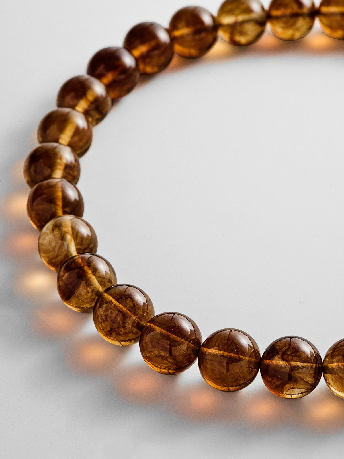Close-up of glossy brown beads on the BaubleBar Mini Jane necklace