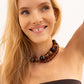 BaubleBar Mini Jane necklace in Tiger's Eye layered with a larger beaded necklace on a model