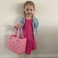 Our adorable little model, showing off the size of a bitty Bogg® bag tote.