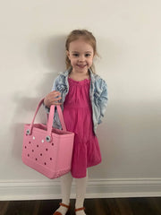 Our adorable little assistant modeling the size of a bitty Bogg® Bag tote.