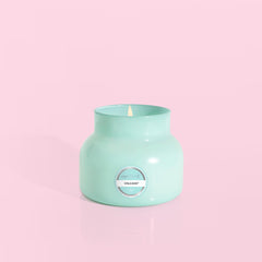 Petite size candle in the color aqua from the brand Capri Blue. The candle is 8 oz. It offers scents of sugared citrus and tropical fruits.