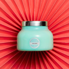 Petite size candle in the color aqua from the brand Capri Blue. The candle is 8 oz. It offers scents of sugared citrus and tropical fruits.