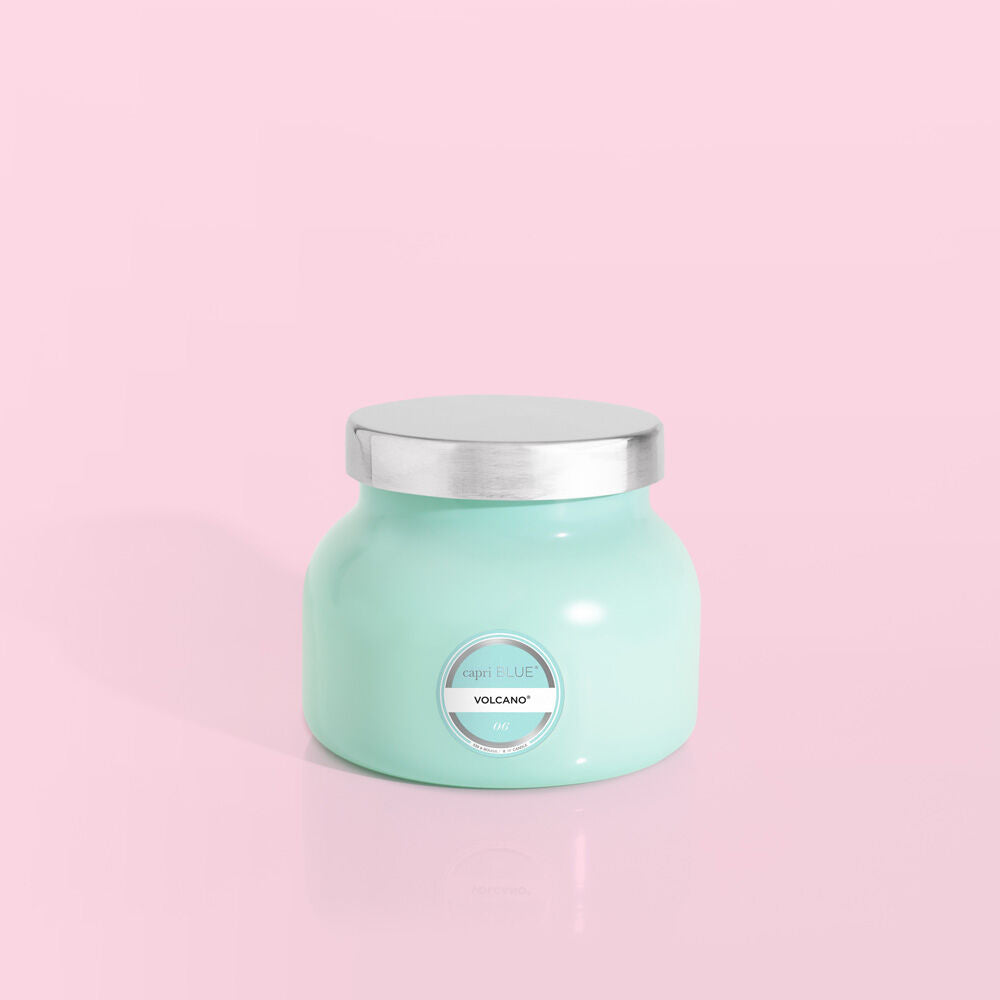 Petite size candle in the color aqua from the brand Capri Blue. The candle is 8 oz. It offers scents of sugared citrus and tropical fruits.