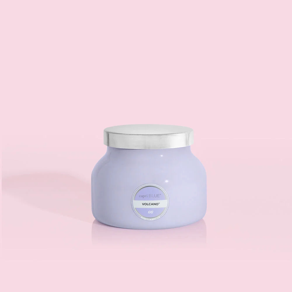 Petite size candle in the color lavender from the brand Capri Blue. The candle is 8 oz and offers a PUNCH of tropical fruits and sugared citrus.