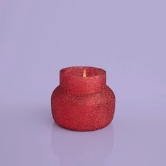 A red 8 oz candle from Capri Blue with volcano scent. 