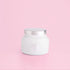 White petite candle from the brand Capri Blue. This candle comes from the Capri Blue Volcano collection. It offers a tropical scent, and is 8 oz.