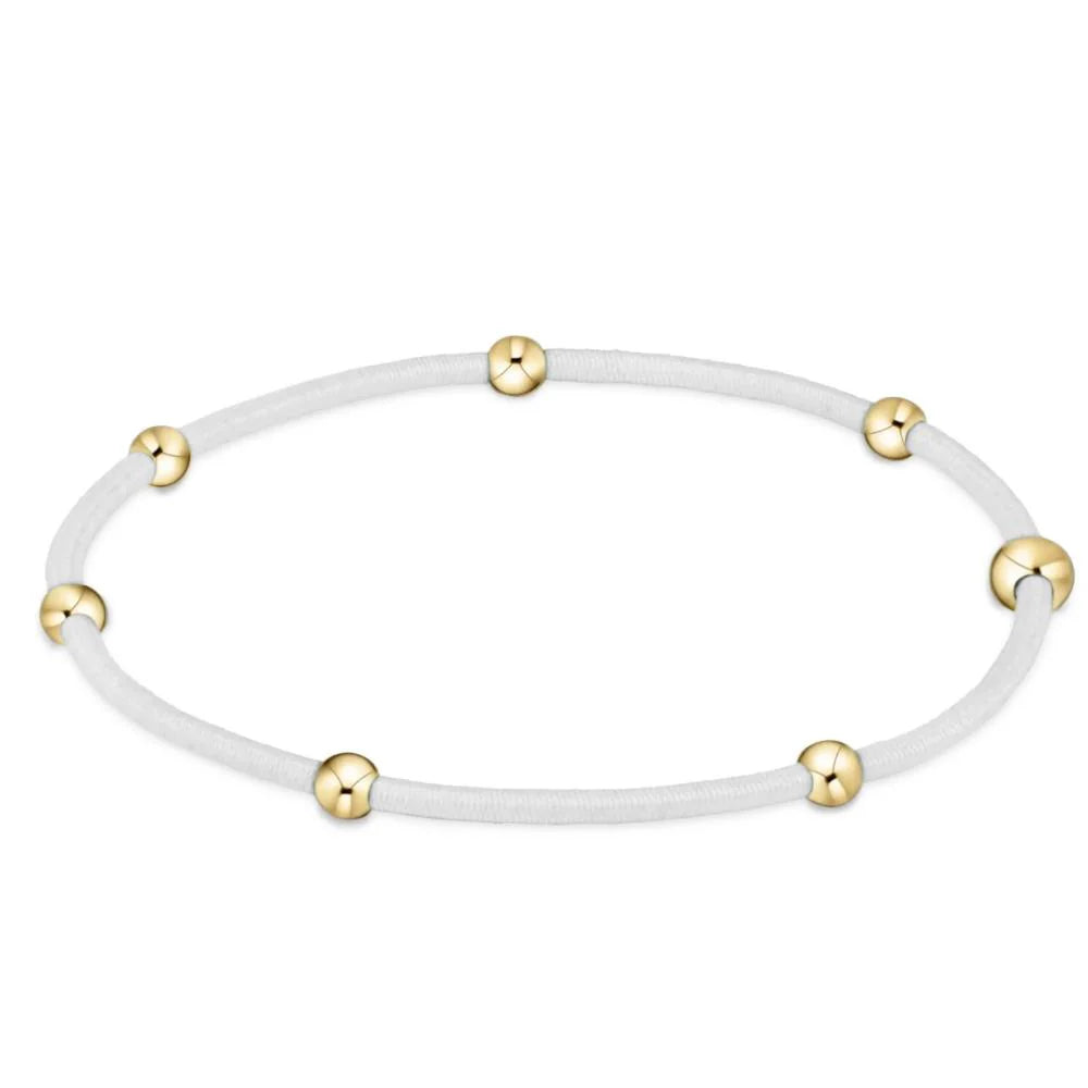 White colored bracelet with gold beads from Enewton.