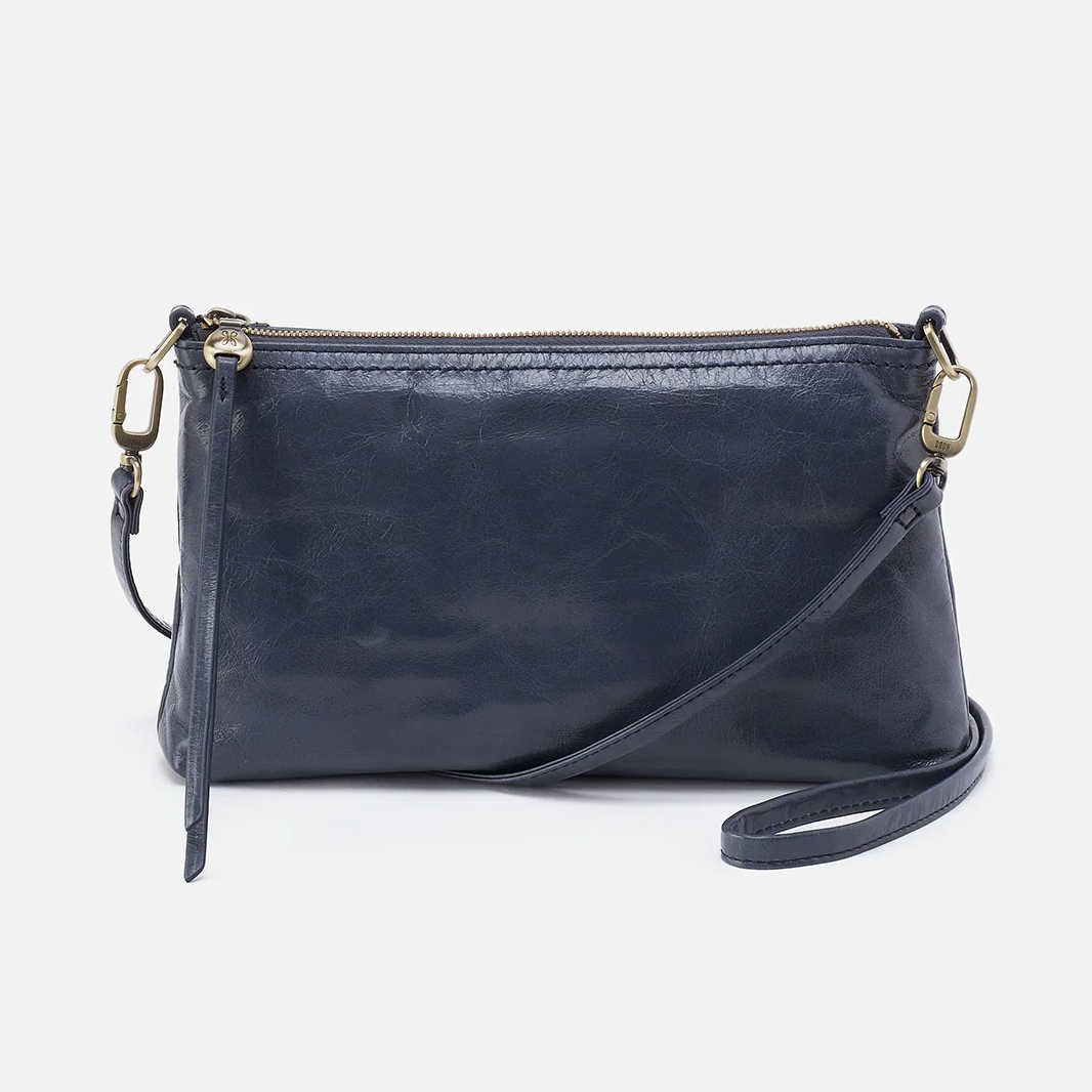 Darcy Crossbody bag designed out of polished leather in the color blue stone. This crossbody is from the handbag brand HOBO.