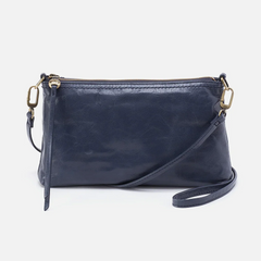 Darcy Crossbody bag designed out of polished leather in the color blue stone. This crossbody is from the handbag brand HOBO.