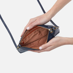 Darcy Crossbody bag designed out of polished leather in the color blue stone. This crossbody is from the handbag brand HOBO.