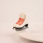 Nora Fleming Rink Ready mini displayed on a serving base (Rink Ready)
