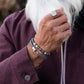 Pig & Hen Catena Foxtail Navy Silver bracelet styled with a burgundy jacket (Navy | Silver)