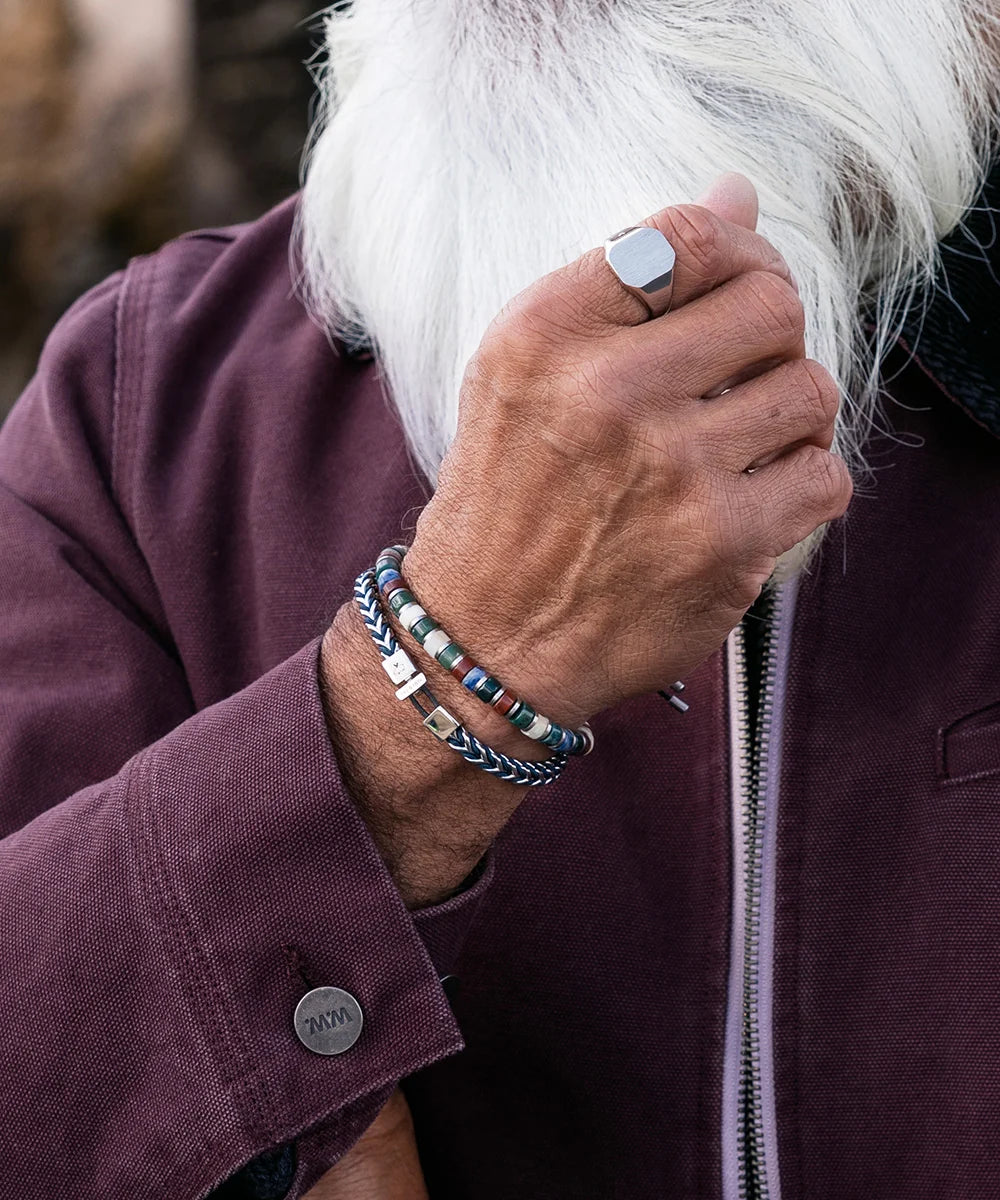 Pig & Hen Catena Foxtail Navy Silver bracelet styled with a burgundy jacket (Navy | Silver)