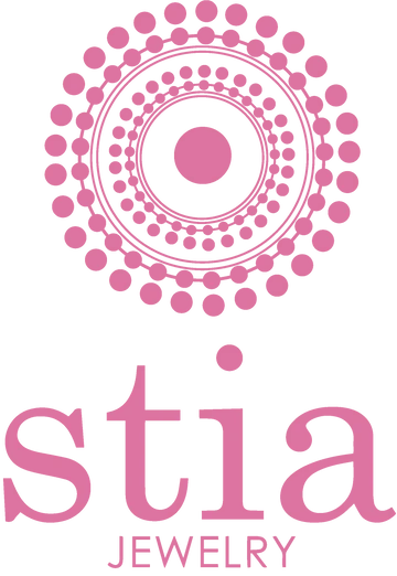 Pink circular dot pattern logo above the text 'stia JEWELRY' on a white background.