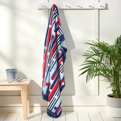 Vera Bradley Beach Towel Summer Stars & Stripes, hanging on a towel rack.