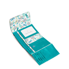 The interior view of the Vera Bradley RFID Riley Compact Wallet In Island Garden Pattern. Showing multiple card slip pockets, bill pockets and a large ID window.