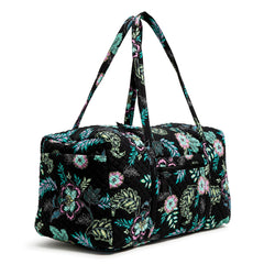 Vera Bradley Large Travel Duffel Bag In Island Garden Pattern, view from the right side of the bag, with the handle straps raised up.