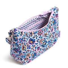 A Vera Bradley Frannie Crescent Crossbody Bag In Cloud Vine Multi Pattern. With the main pocket unzipped, showing the interior of the handbag.