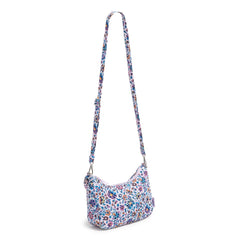 A Vera Bradley Frannie Crescent Crossbody Bag In Cloud Vine Multi Pattern. With the crossbody strap fully extended.