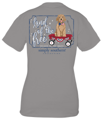 Back view of a Simply Southern Women's Land of the Free Short Sleeve Tee. Showing a Golden Doodle sitting in a little red wagon, while wearing an American flag bow tie.
