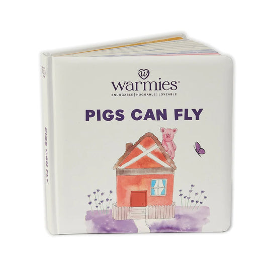 Warmies® "Pig Can Fly" children's book. Showing a pink pig sitting on a red house. 1080