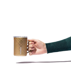 A hand gripping the mug at the handle.