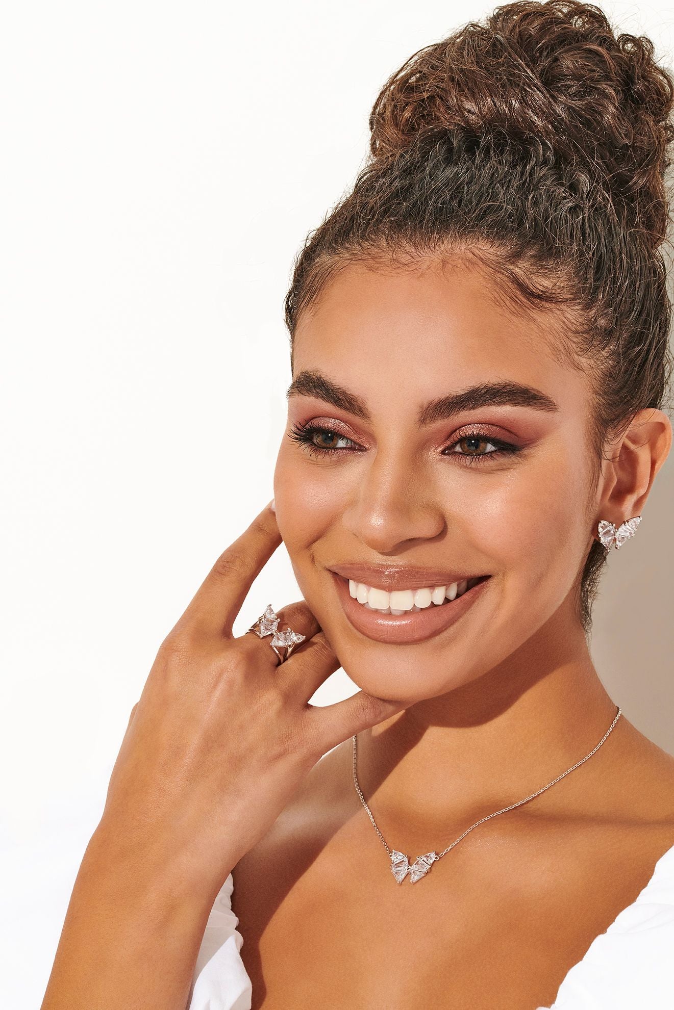 A model wearing the Kendra Scott butterfly stud earrings, a butterfly ring and necklace.